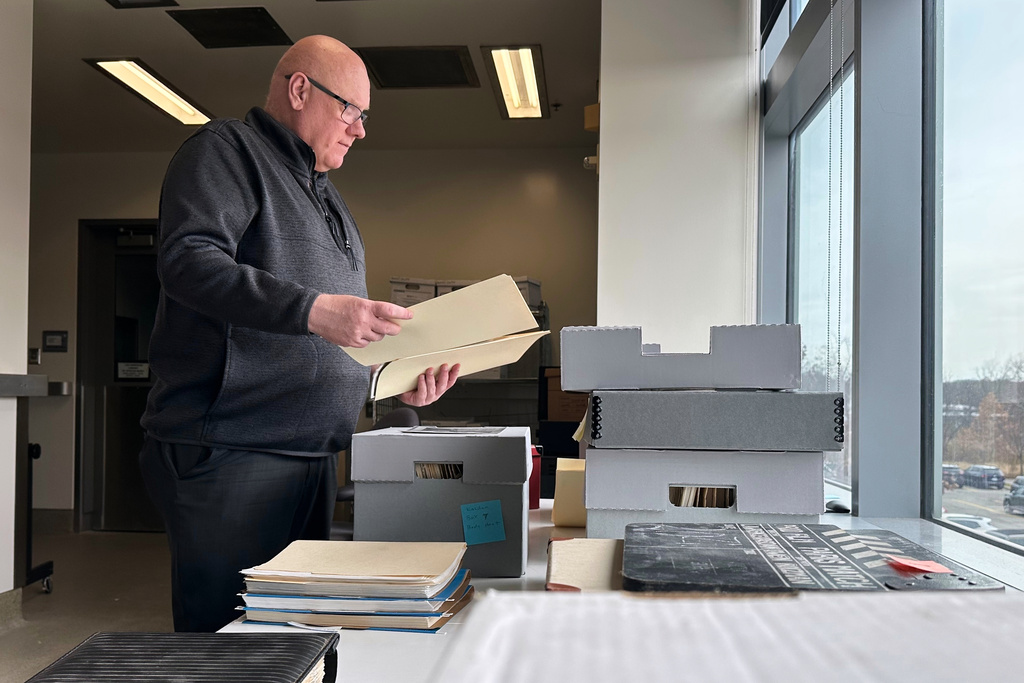 Phil Hallman, a University of Michigan film studies librarian, looks through folders in the Lawrence Kasdan collection, Nov. 24, 2025, in Ann Arbor, Mich. (AP Photo/Mike Householder)