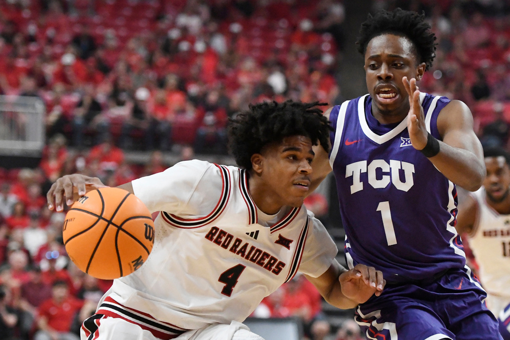 Texas Tech guard Christian Anderson (4) dribbles the ball while TCU guard Jayden Pierre (1) guards during the first half in an NCAA college basketball game, Tuesday, March 3, 2026, in Lubbock, Texas. (AP Photo/Annie Rice)