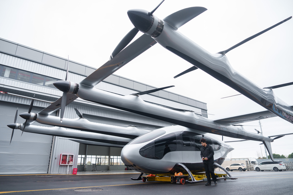 CORRECTS LOCATION A mechanic moves out a 5-ton class eVTOL aircraft from AutoFlight hanger in Kunshan city in China's Jiangsu province, China, on Feb. 24, 2026. (AP Photo/Vincent Thian)