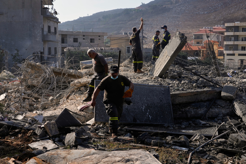 Rescue workers search for victims under the rubble of a building destroyed in an Israeli airstrike in the southern village of Kfar Rumman, Lebanon, Monday, Sept. 7, 2026. (AP Photo/Mohammed Zaatari)