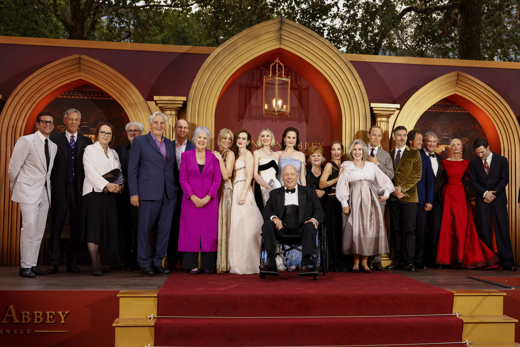 Allen Leech, from back left, Douglas Reith, producer Liz Trubridge, director Simon Curtis, Jim Carter, Kevin Doyle, Penelope Wilton, Raquel Cassidy, Sophie McShera, Laura Carmichael, Michelle Dockery, Lesley Nicol, Joanne Froggatt, Phyllis Logan, Harry Hadden-Paton, Rob James-Collier, Dominic West, Hugh Bonneville, Joely Richardson and Arty Froushan pose for photographers upon arrival at the world premiere of the film 'Downton Abbey: The Grand Finale' on Wednesday, Sept. 3, 2025, in London. (Photo by Millie Turner/Invision/AP)