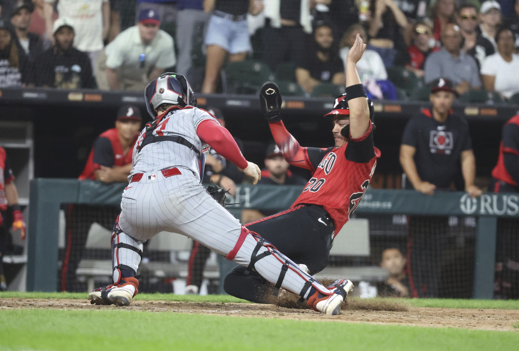 Minnesota Twins catcher Ryan Jeffers (27) tags out Chicago White Sox third baseman Miguel Vargas (20) during the eighth inning of a baseball game, Friday, Aug. 22, 2025, in Chicago. (AP Photo/Talia Sprague)