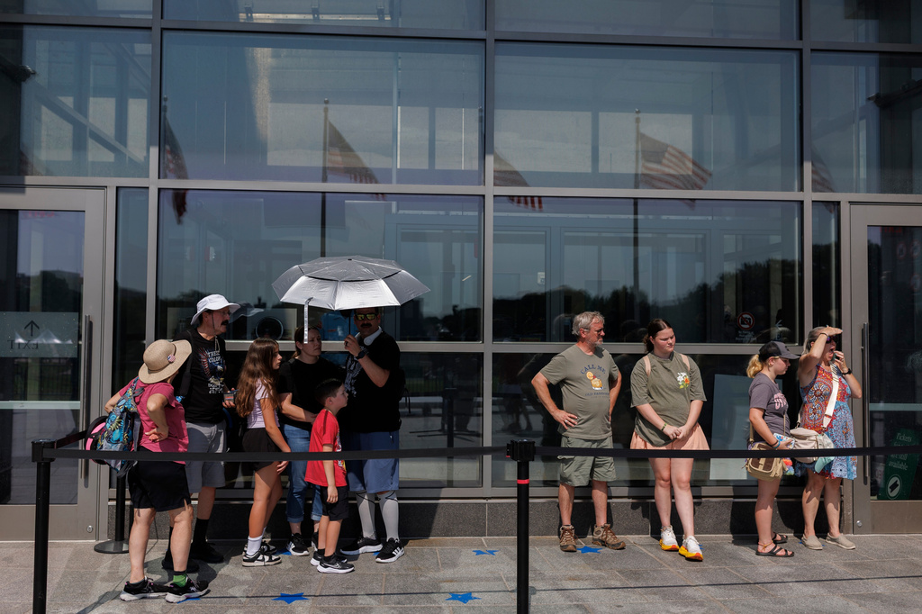 Visitors wait to enter the Washington Monument, Wednesday, July 1, 2026, in Washington. (AP Photo/Tom Brenner)