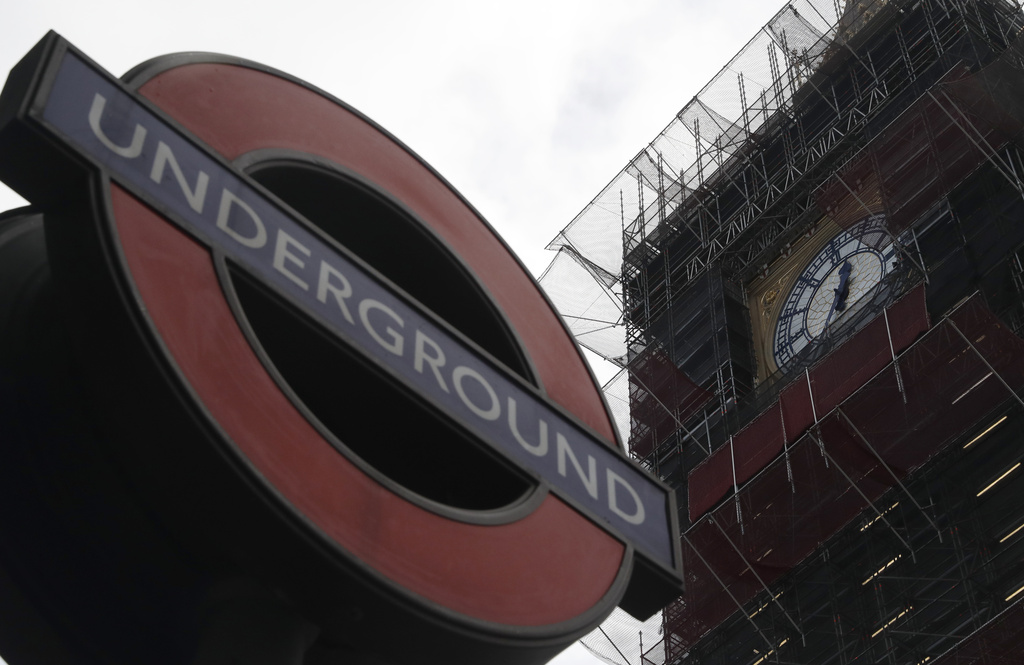 FILE - A London Underground sign at Westminster station with the Queen Elizabeth Tower in the background that holds the bell known as Big Ben in London, March 15, 2021. (AP Photo/Alastair Grant, file)