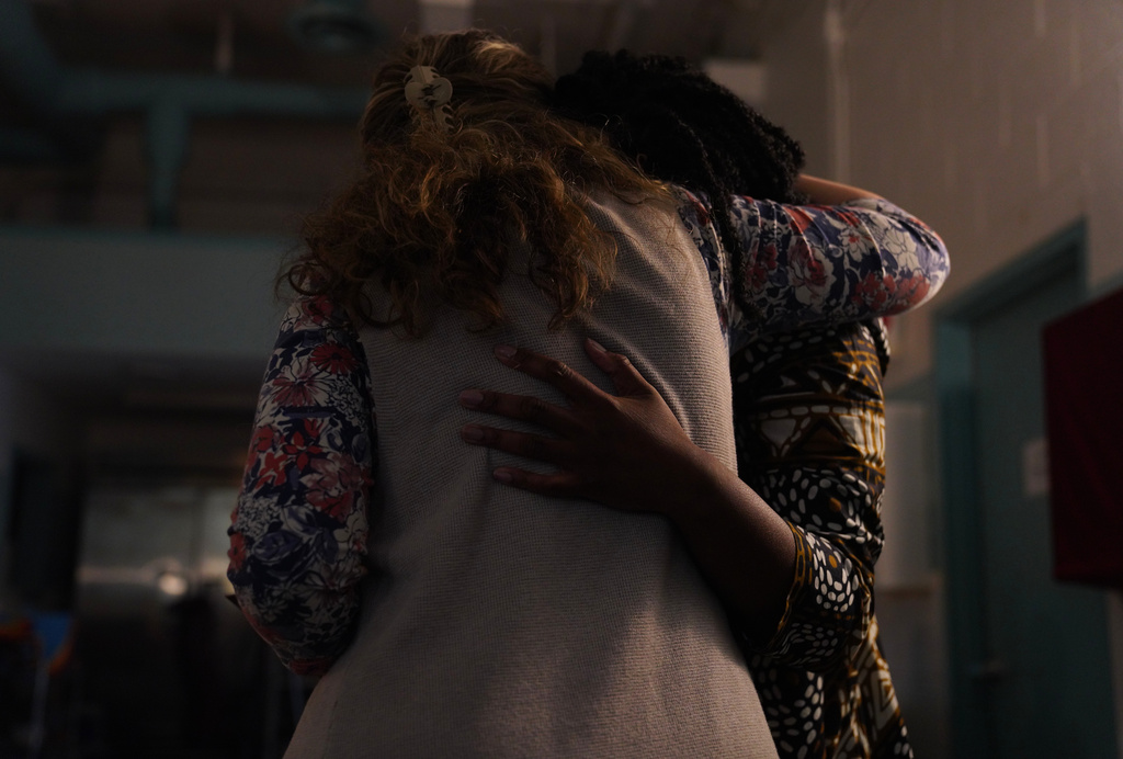 Andrea Danko-Barna, left, hugs Fidelia Gaba, a University of Pittsburgh medical student and Orthodox convert, during Gaba's chrismation service, in which she was confirmed as a member of St. Moses the Black Orthodox Church, Sunday, Nov. 9, 2025, in Pittsburgh. (AP Photo/Jessie Wardarski)