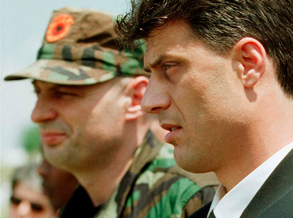 FILE - Kosovo Liberation Army leader Hashim Thaci, right, and KLA general commander Agim Ceku attend a memorial ceremony for ethnic Albanian leader Fehmi Agani in Pristina, Kosovo, Friday, Aug. 6, 1999. (AP Photo/Lefteris Pitarakis, File)