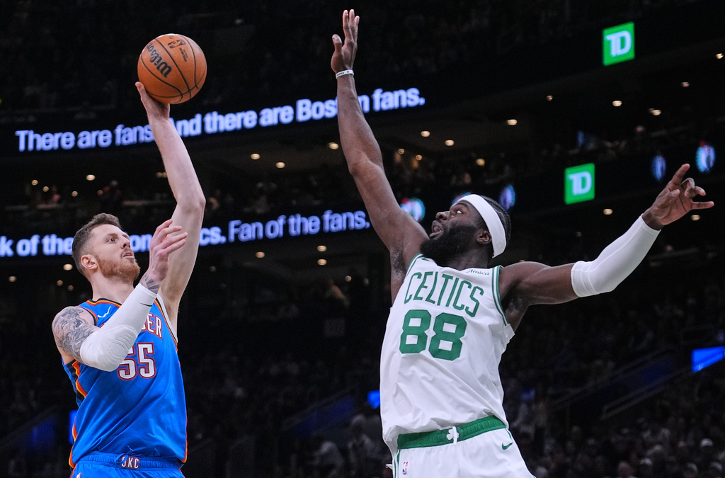 Oklahoma City Thunder center Isaiah Hartenstein (55) takes a shot over Boston Celtics center Neemias Queta (88) during the first half of an NBA basketball game, Wednesday, March 25, 2026, in Boston. (AP Photo/Charles Krupa)