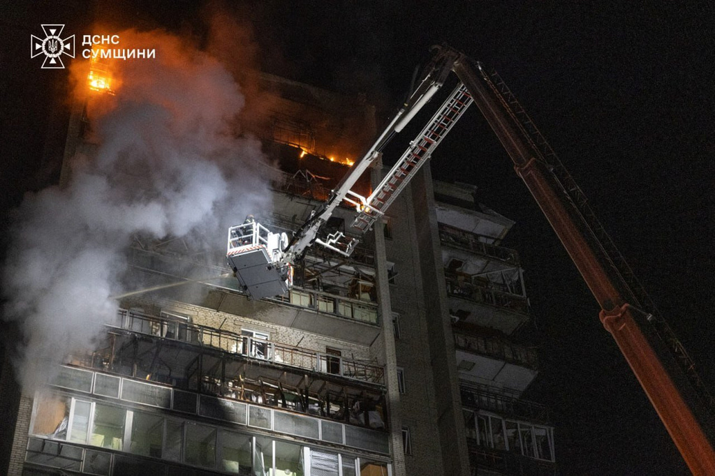 In this photo provided by the Ukrainian Emergency Services on Saturday, April 4, 2026, rescue workers put out a fire of a residential building damaged following a Russian strike in Sumy, Ukraine. (Ukrainian Emergency Service via AP)