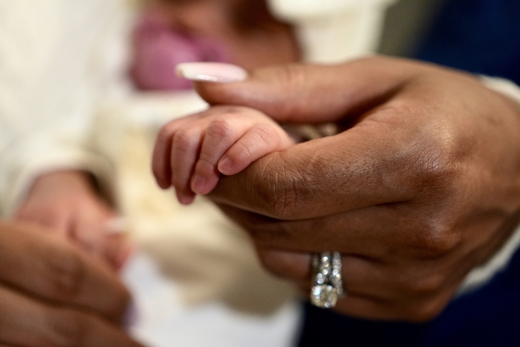 Mercedes Wells hold her newborn daughter Alena at their home in the Chicago suburb of Dolton, Ill. on Friday, Nov. 28, 2025. (AP Photo/Mark Vancleave)