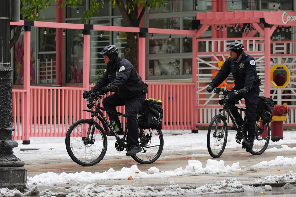 Chicago Police officers ride their bicycle as they are patrolling on the sidewalk during a cold day in Chicago, Tuesday, Nov. 11, 2025. (AP Photo/Nam Y. Huh)