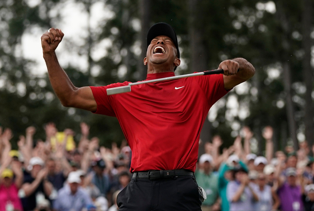 FILE - Tiger Woods reacts as he wins the Masters golf tournament, Sunday, April 14, 2019, in Augusta, Ga. (AP Photo/David J. Phillip, File)