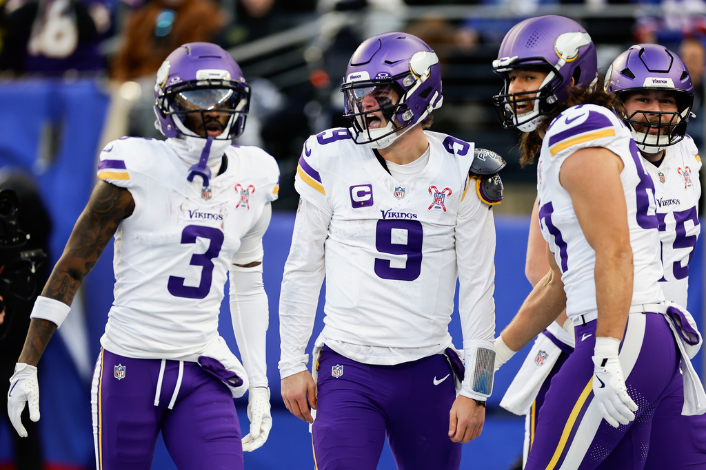 Minnesota Vikings quarterback J.J. McCarthy (9) celebrates with teammates after scoring a touchdown against the New York Giants during the second quarter of an NFL football game, Sunday, Dec. 21, 2025, in East Rutherford, N.J. (AP Photo/Adam Hunger)