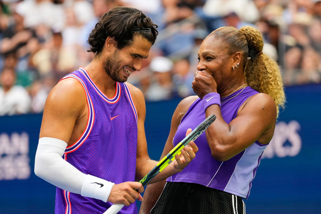 Carlos Alcaraz, of Spain, left, and Serena Williams, of the United States, talk on the court during a mixed doubles match at the U.S. Open tennis championships, Tuesday, Aug. 25, 2026, in New York. (AP Photo/Yuki Iwamura)