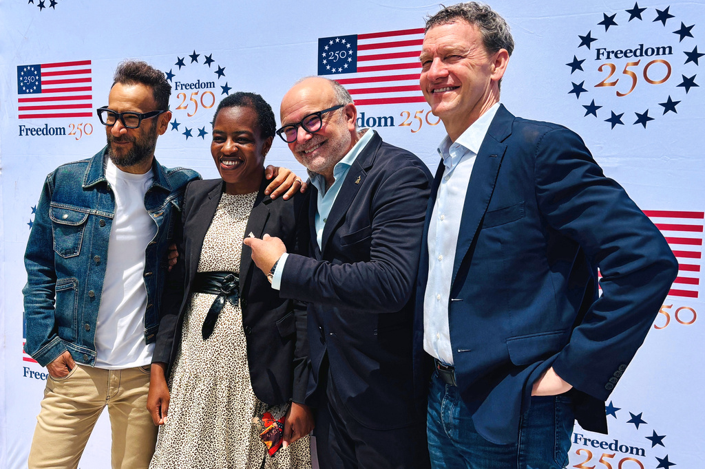 In this photo taken with a smartphone, The Recording Academy President Panos A. Panay, left, The Latin America Recording Academy CEO Manuel Abud, center, and Nicholas Weinstock, right, pose with a staff member from the U.S. embassy on Friday, Sept. 11, 2026, in Nairobi, Kenya. (AP Photo/Jackson Njehia)