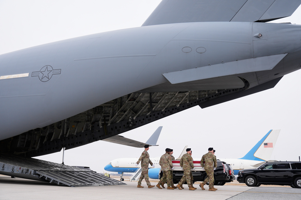 An Army carry team moves a flag-draped transfer case with the remains of Sgt. 1st Class Noah Tietjens, 42, of Bellevue, Neb., who was killed in a drone strike at a command center in Kuwait after the U.S. and Israel launched its military campaign against Iran, during a casualty return, Saturday, March 7, 2026, at Dover Air Force Base, Del. (AP Photo/Mark Schiefelbein)