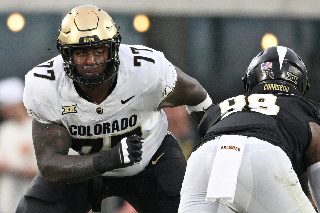 FILE - Colorado offensive tackle Jordan Seaton (77) sets up to block against Central Florida defensive end Jamaal Johnson (99) during the second half of an NCAA college football game, Saturday, Sept. 28, 2024, in Orlando, Fla. (AP Photo/Phelan M. Ebenhack, File)