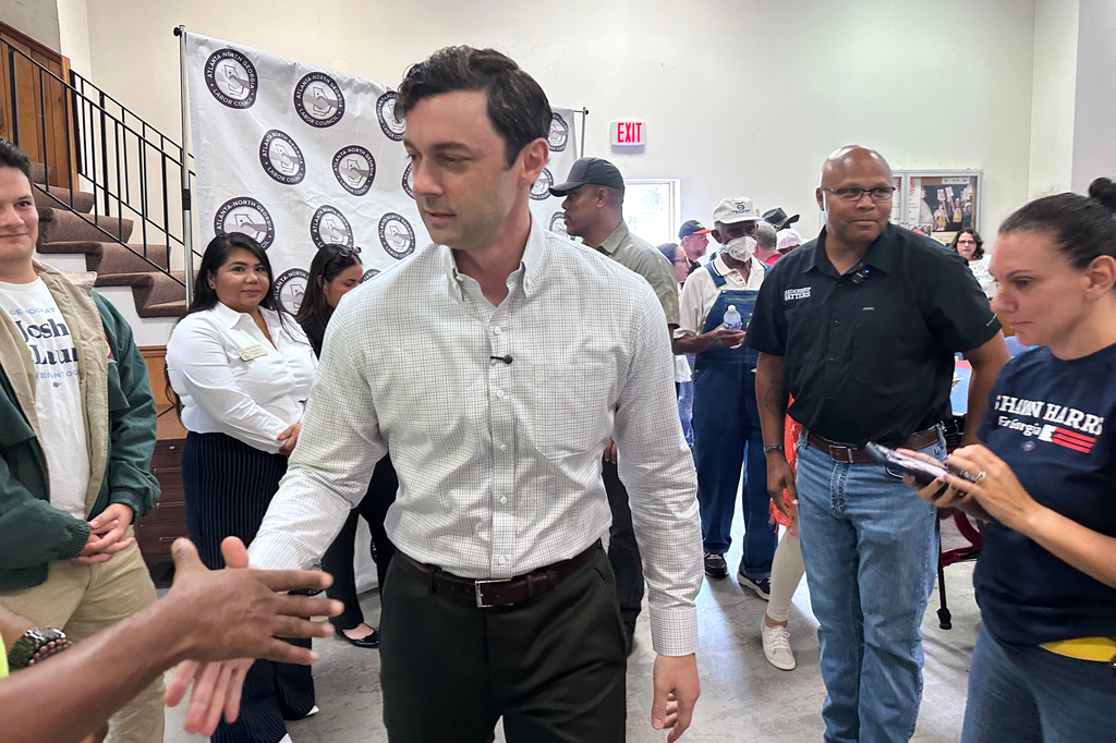 This photo taken with a smartphone shows Sen. Jon Ossoff, D-Ga., greeting union members at an Atlanta-North Georgia Labor Council (AFL-CIO) Labor Day lunch in Hapeville, Ga., Monday, Sept. 7, 2026. (AP Photo/Bill Barrow)