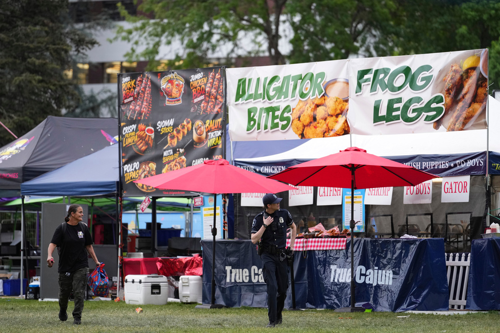 Police respond to a shooting at Seattle Center during the Bite of Seattle food festival Sunday, July 26, 2026, in Seattle, Wash. (AP Photo/Lindsey Wasson)