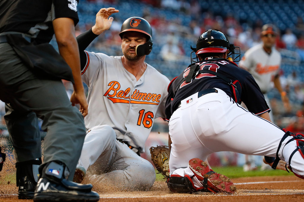 FILE - Baltimore Orioles' Trey Mancini (16) is safe at home before the tag by Washington Nationals catcher Yan Gomes during the first inning of a baseball game at Nationals Park, Aug. 27, 2019, in Washington. (AP Photo/Alex Brandon, File)
