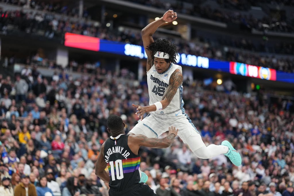 Memphis Grizzlies forward GG Jackson, top, loses control of the ball while driving to the basket and drawing a foul on Denver Nuggets guard Tim Hardaway Jr. in the first half of an NBA basketball game Wednesday, Feb. 11, 2026, in Denver. (AP Photo/David Zalubowski)