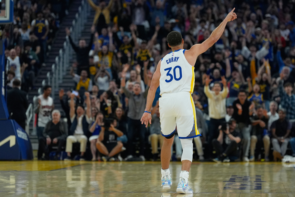 Golden State Warriors guard Stephen Curry celebrates after making a 3-point basket during the first half of an NBA basketball game against the Houston Rockets, Sunday, April 5, 2026, in San Francisco. (AP Photo/Godofredo A. Vásquez)