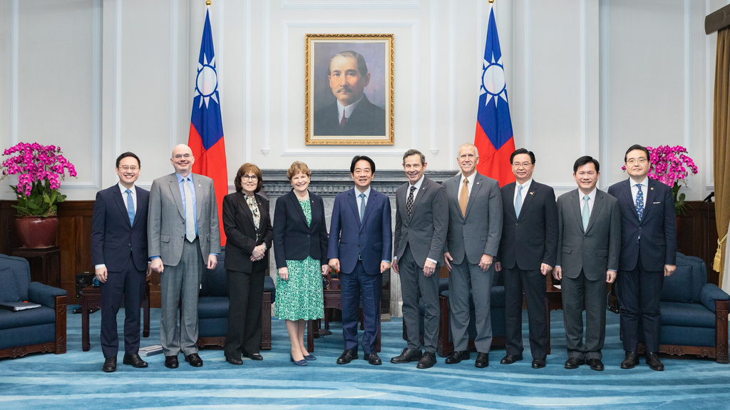 In this photo, released by the Taiwan Presidential Office, Taiwan's President William Lai Ching-te, center, poses for photos with visiting U.S. lawmakers including US Sen. Jeanne Shaheen, fourth from left, John Curtis, fifth from right, Thom Tillis, fourth from right and Jacky Rosen, third from left, in Taipei, Taiwan, Monday, March 30, 2026. (Taiwan Presidential Office via AP)