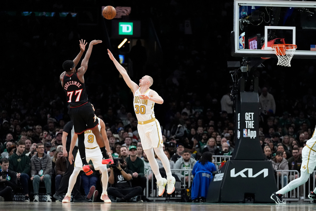 Philadelphia 76ers guard VJ Edgecombe (77) shoots over Boston Celtics forward Sam Hauser (30) during the first half of an NBA basketball game, Sunday, March 1, 2026, in Boston. (AP Photo/Robert F. Bukaty)
