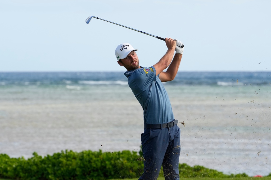 Adam Svensson, of Canada, hits from the 17th tee during the third round of the Sony Open golf event at the Waialae Country Club in Honolulu, Saturday, Jan. 17, 2026. (AP Photo/Matt York)