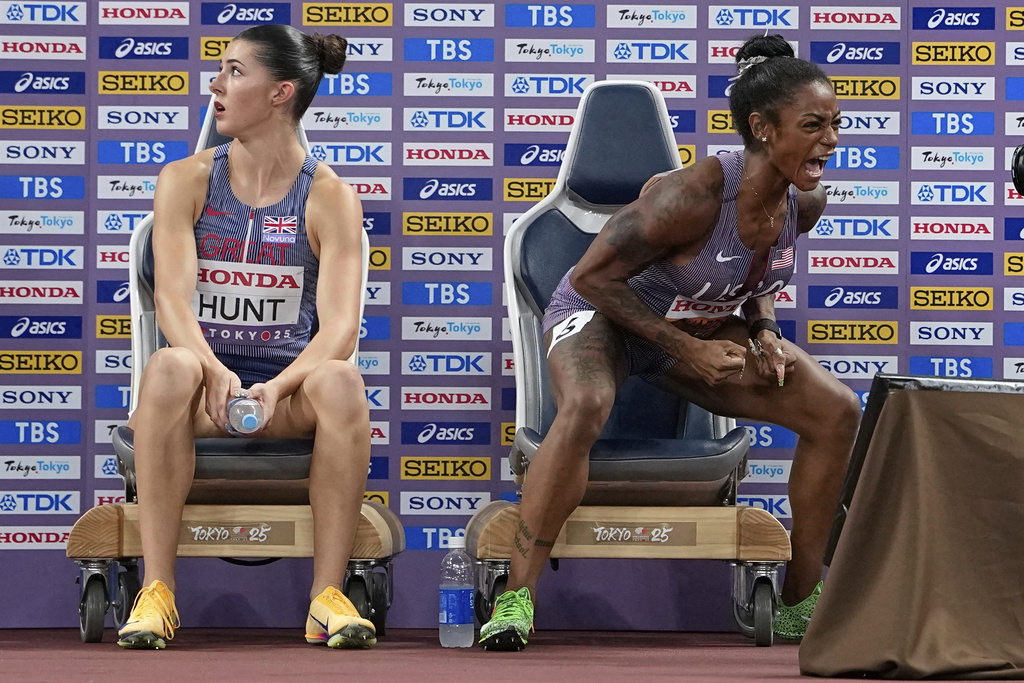 United States' Sha'Carri Richardson celebrates after qualifying for the women's 100 meters final as Britain's Amy Hunt reacts at the World Athletics Championships in Tokyo, Sunday, Sept. 14, 2025. (AP Photo/Ashley Landis)