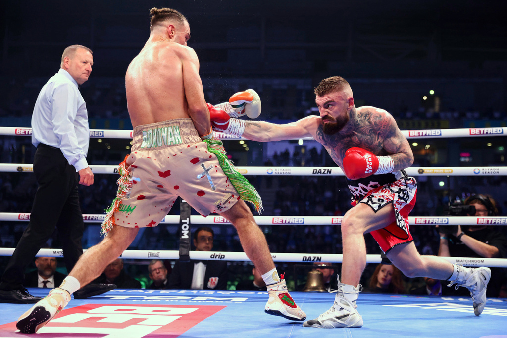 Paddy Donovan, left, takes on Lewis Crocker, right, during an IBF world welterweight bout at the SSE Arena, Saturday, Sept. 13, 2025, in Belfast, Northern Ireland. (Peter Morrison/PA via AP)