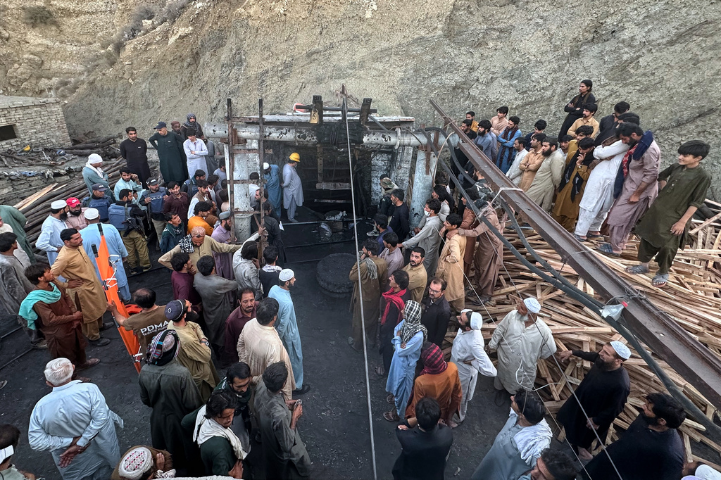 People gather as rescue workers attempt to reach miners trapped in a coal mine on the outskirts of Quetta, the capital of Baluchistan province, in southwest Pakistan, Thursday, July 30, 2026. (AP Photo/Fazal Tawab)