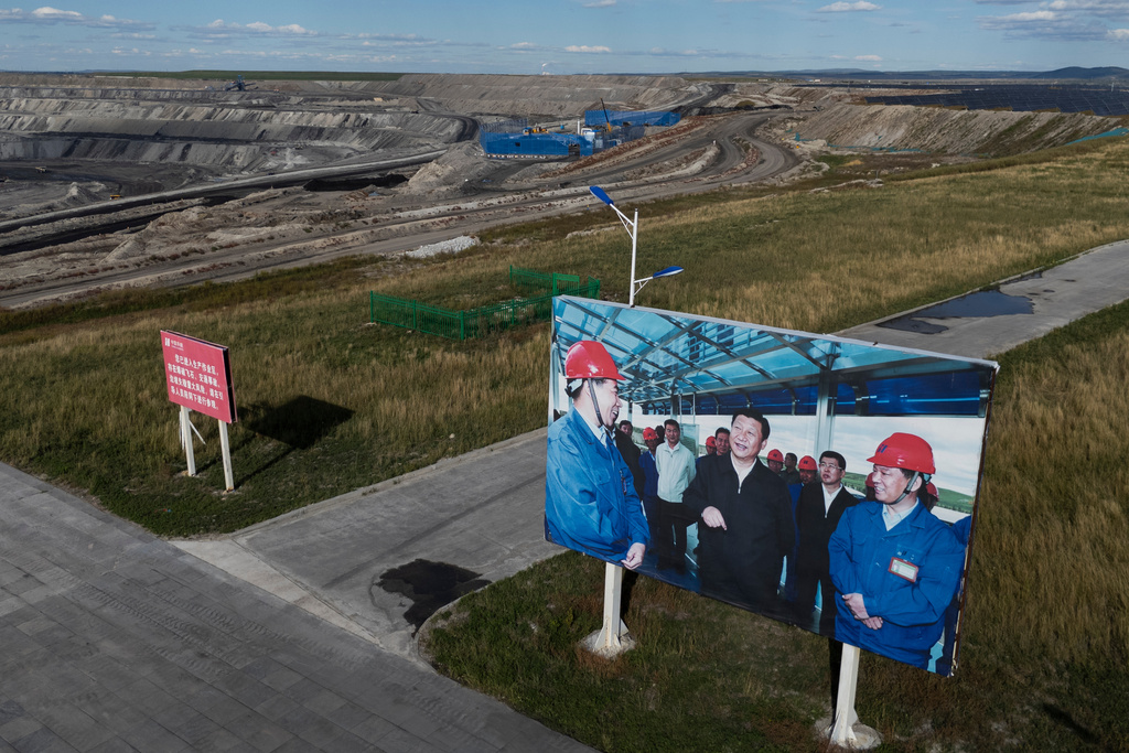 A board shows Chinese President Xi Jinping during his visit to the Huaneng Yimin open-pit coal mine in Hulunbuir in northern China's Inner Mongolia province China, Monday, Sept. 15, 2025. (AP Photo/Ng Han Guan)