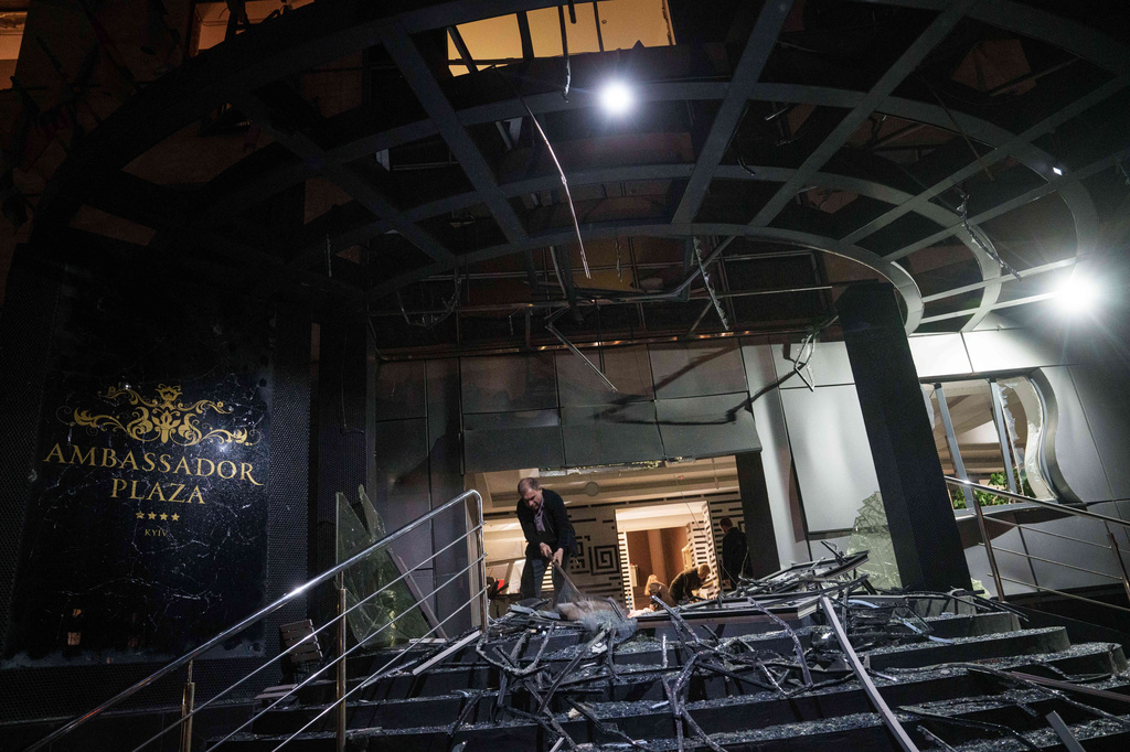 A man clear the rubble of a hotel damaged after a Russian strike on residential area in Kyiv, Ukraine, on Thursday, April 16, 2026. (AP Photo/Evgeniy Maloletka)