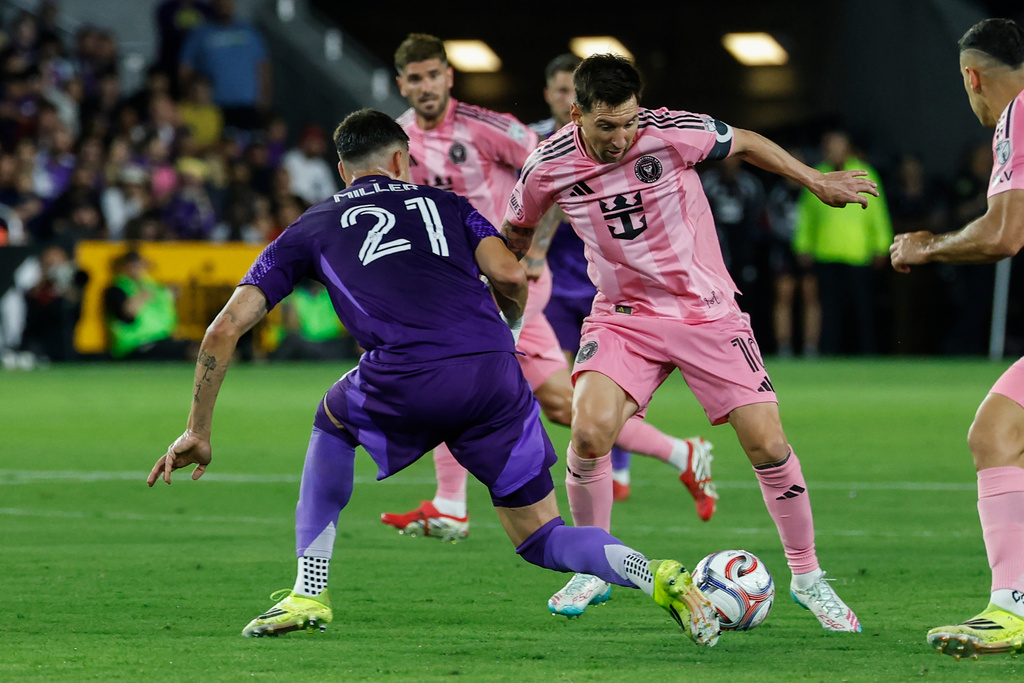 Inter Miami CF forward Lionel Messi, right, controls the ball as he is defended by Orlando City SC defender Nolan Miller (21) during the first half of an MLS soccer match, Sunday, March 1, 2026, in Orlando, Fla. (AP Photo/Kevin Kolczynski)