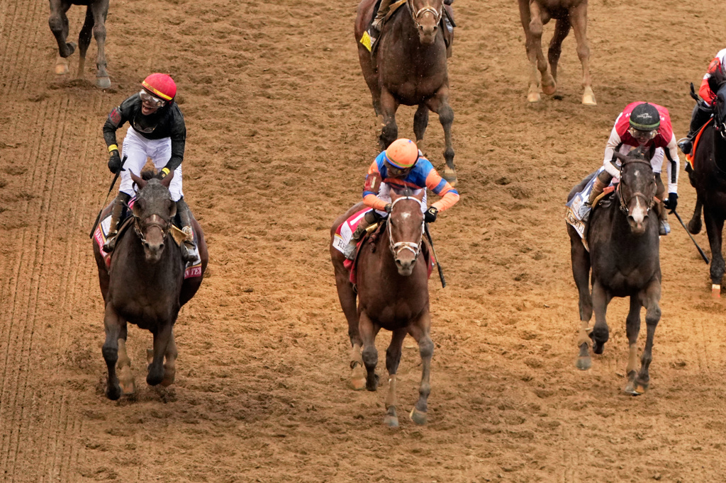 Jockey Jose L. Ortiz celebrates after riding Golden Tempo, left, to victory the 152nd running of the Kentucky Derby horse race at Churchill Downs, Saturday, May 2, 2026, in Louisville, Ky. (AP Photo/Charlie Riedel)