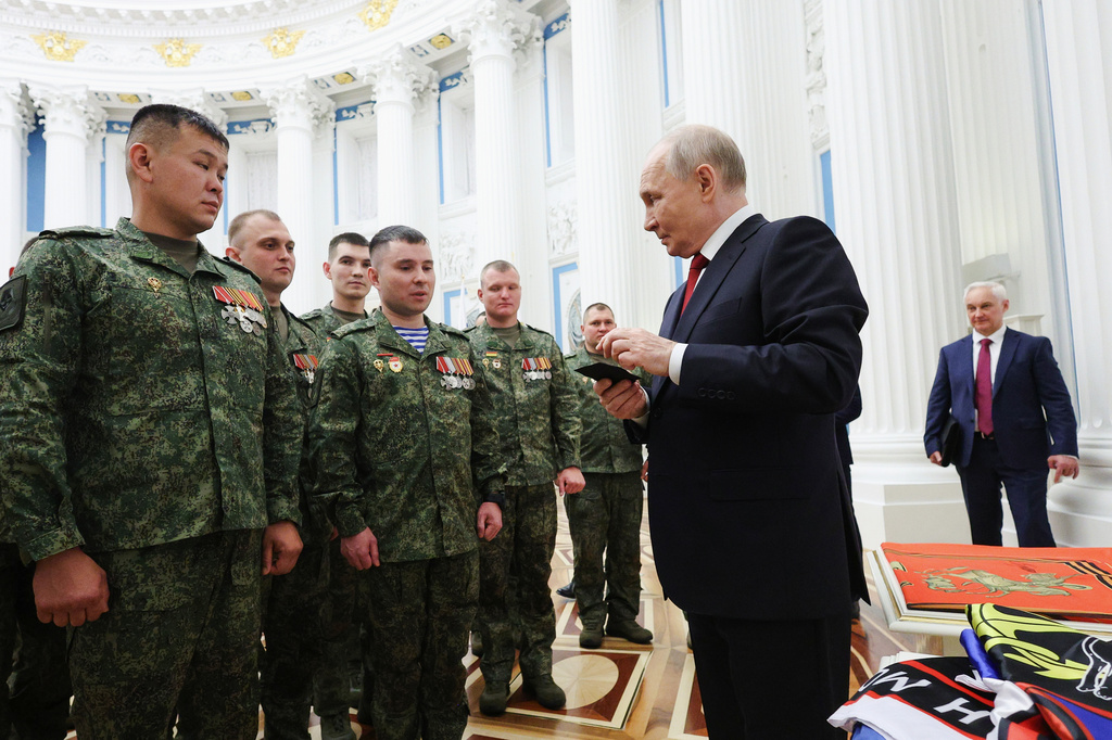 FILE - Russian President Vladimir Putin, foreground right, speaks with members of the military in the Kremlin in Moscow on Friday, June 12, 2026, as Defense Minister Andrei Belousov, right, stands nearby. (Vyacheslav Prokofyev, Sputnik, Kremlin Pool Photo via AP, File)