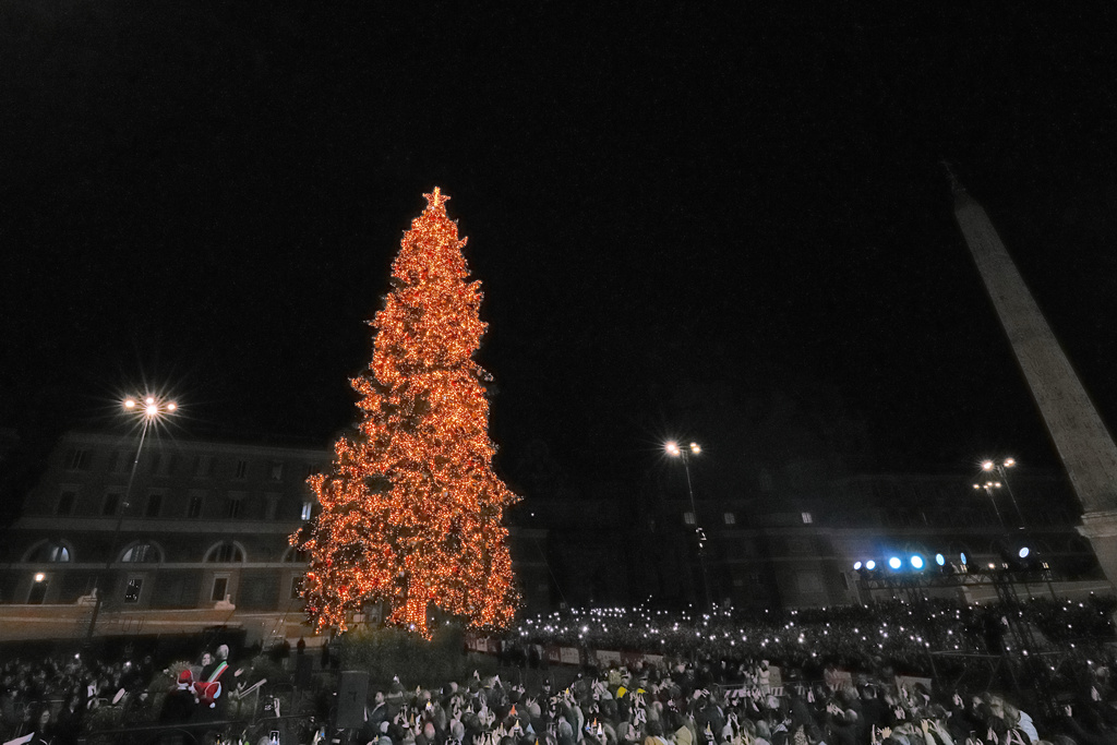 Rome's Mayor Roberto Gualtieri, left, lights up a giant Christmas tree in central Piazza del Popolo in Rome, Monday, Dec. 8, 2025. (AP Photo/Andrew Medichini)