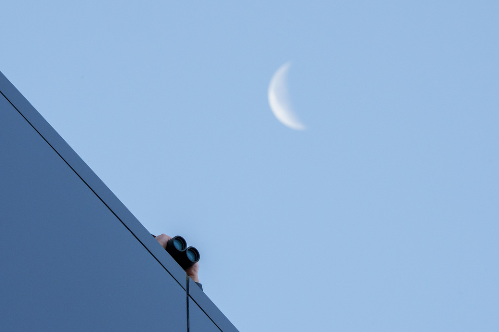 A law enforcement officer uses binoculars to watch from the roof of the Fourth District Courthouse in Provo, Utah, Thursday, July 9, 2026, before a preliminary hearing for Tyler Robinson, who is accused in the fatal shooting of Charlie Kirk. (AP Photo/Spenser Heaps)
