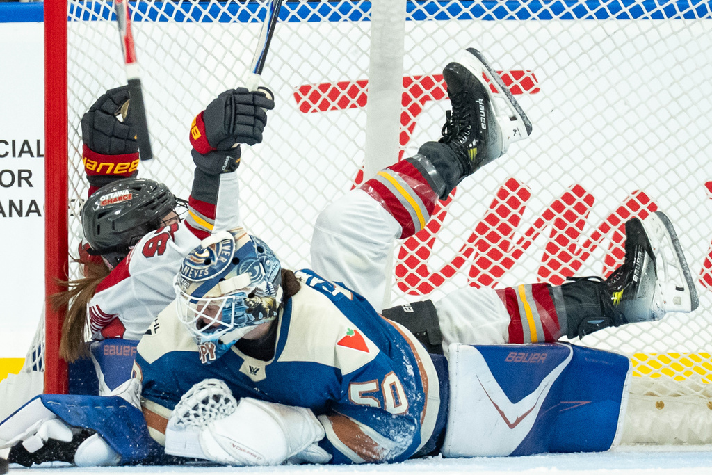 Ottawa Charge's Anna Shokhina (97) celebrates her goal as she trips over Vancouver Goldeneyes goaltender Kristen Campbell (50) during the third period of a PWHL hockey game in Vancouver, British Columbia, Tuesday, Dec. 16, 2025. (Ethan Cairns/The Canadian Press via AP)