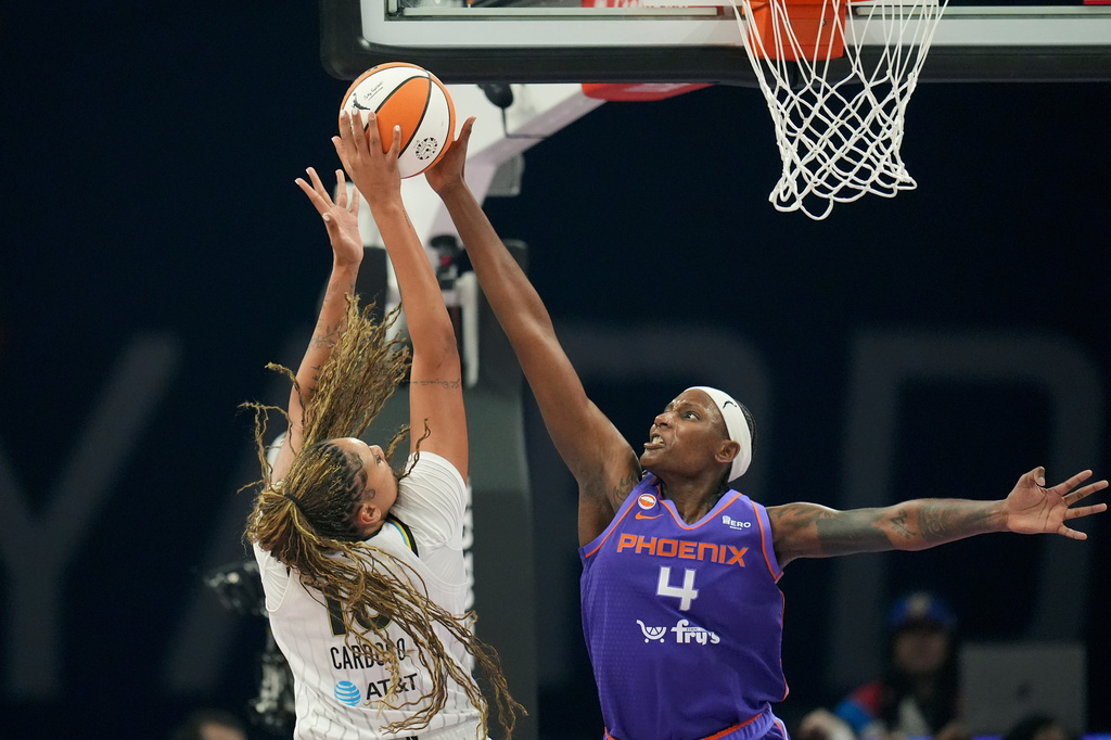 Phoenix Mercury center Natasha Mack (4) blocks a shot by Chicago Sky center Kamilla Cardoso during the first half of a WNBA basketball game, Friday, May 15, 2026, in Phoenix. (AP Photo/Ross D. Franklin)