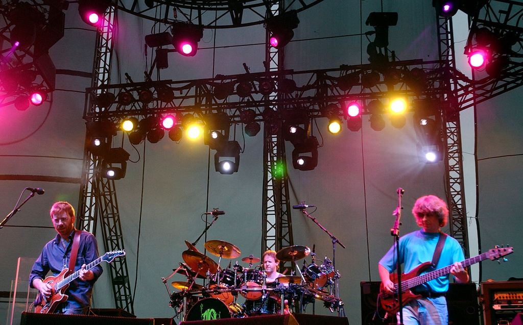FILE - Phish's Trey Anastasio, left, drummer Jon Fishman, center, and bassist Mike Gordon perform with the band at Keyspan Park in the Brooklyn borough of New York Thursday, June 17, 2004. (AP Photo/Chad Rachman, File)