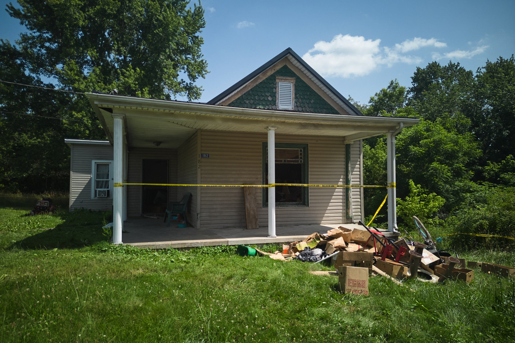FILE - Police tape surrounds a home where authorities say they removed 16 children and arrested four adults in Hamden, Ohio, July 1, 2026. (AP Photo/Carolyn Kaster, File)