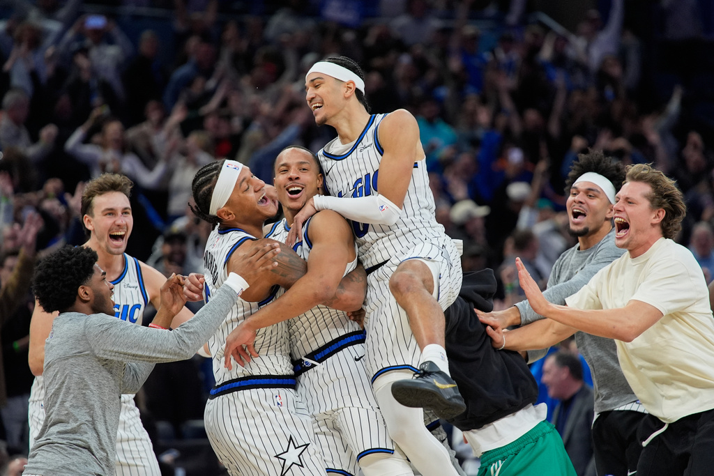 Orlando Magic guard Desmond Bane, center, celebrates with teammates after making the game winning shot against the Portland Trail Blazers at the buzzer in an NBA basketball game, Monday, Nov. 10, 2025, in Orlando, Fla. (AP Photo/John Raoux)
