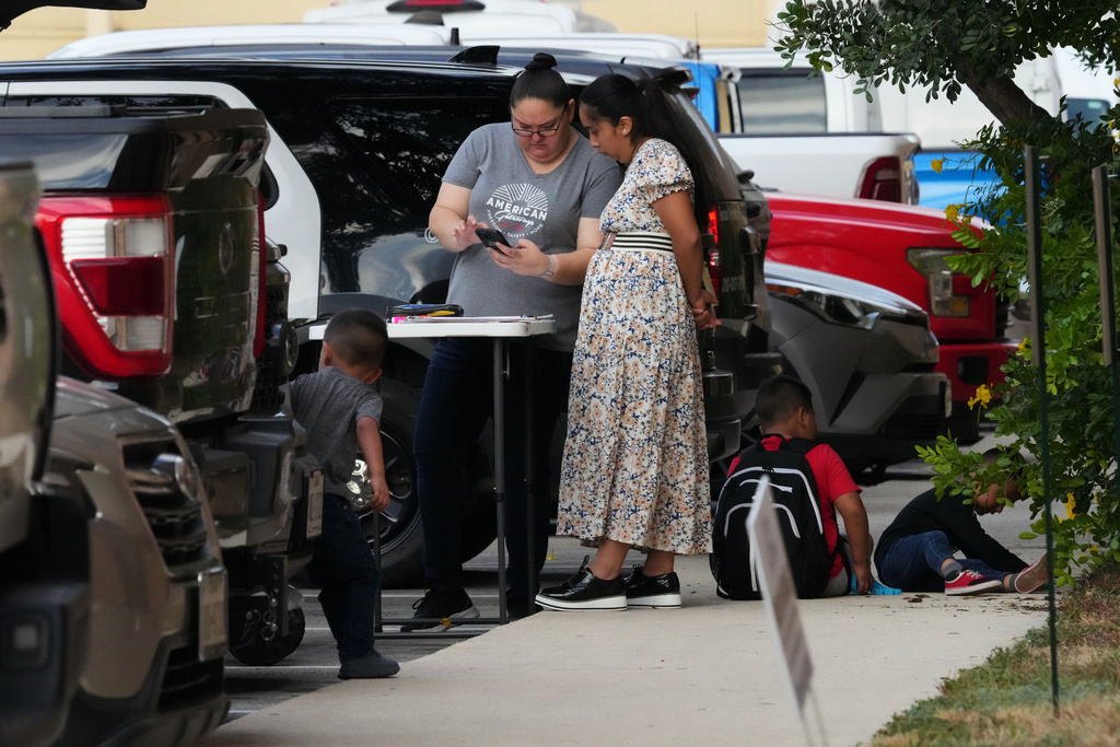 American Gateways attorney Erika Gonzalez talks with a woman before she attends her court hearing, Wednesday, Sept. 24, 2025, in San Antonio. (AP Photo/Eric Gay)