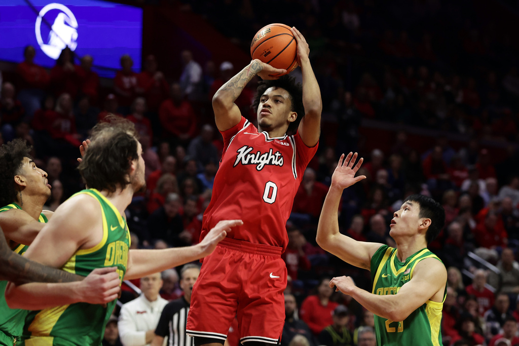 Rutgers guard Tariq Francis (0) looks to shoot in front of Oregon guard Wei Lin, right, during the second half of an NCAA college basketball game Monday, Jan. 5, 2026, in Piscataway, N.J. (AP Photo/Adam Hunger)