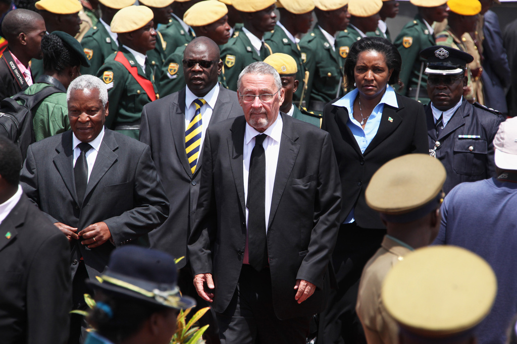 FILE - Zambian deputy President Guy Scott, center, attends the burial of Deputy President John Nkomo at the Heroes Acre in Harare, Zimbabwe, Jan, 21, 2013. (AP Photo/Tsvangirayi Mukwazhi, File)