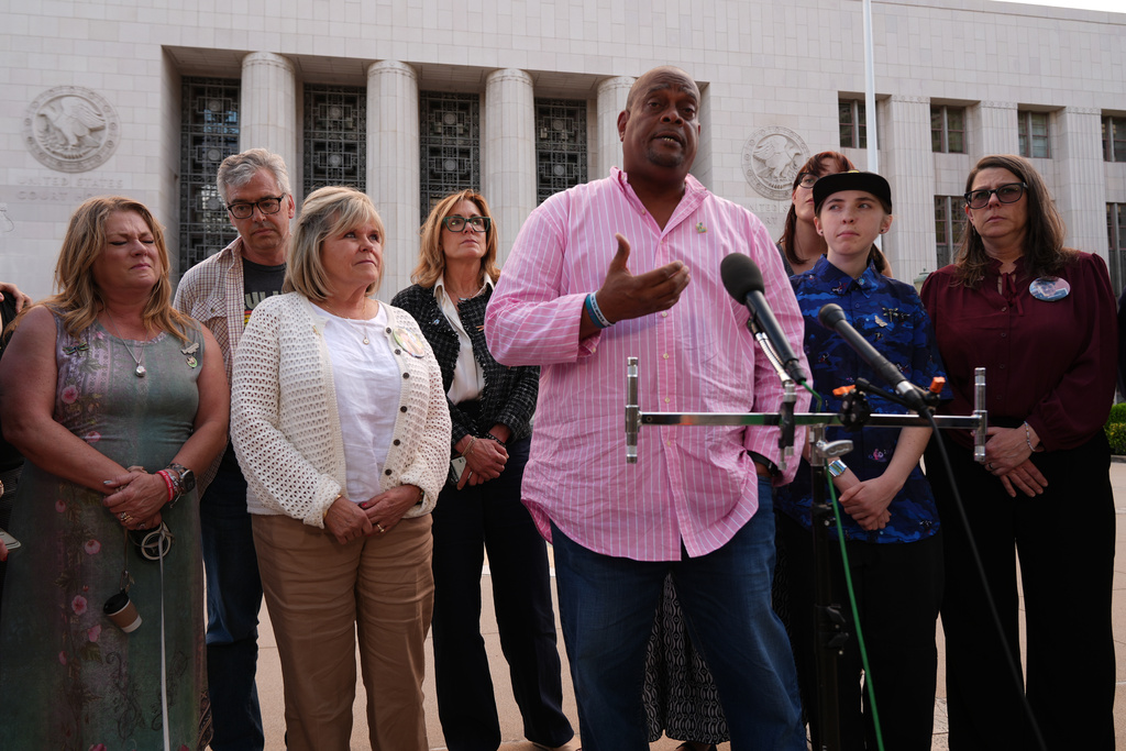Tony Roberts, father of late Englyn Roberts, 14, is surrounded by other parents of child victims of social media platforms, as he speaks to the media outside Los Angeles Superior Court at United States Courthouse on Thursday, March 12, 2026, in Los Angeles. (AP Photo/Damian Dovarganes)