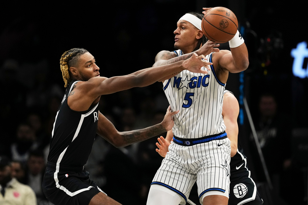 Brooklyn Nets' Noah Clowney, left, defends Orlando Magic's Paolo Banchero (5) during the first half of an NBA basketball game Wednesday, Jan. 7, 2026, in New York. (AP Photo/Frank Franklin II)