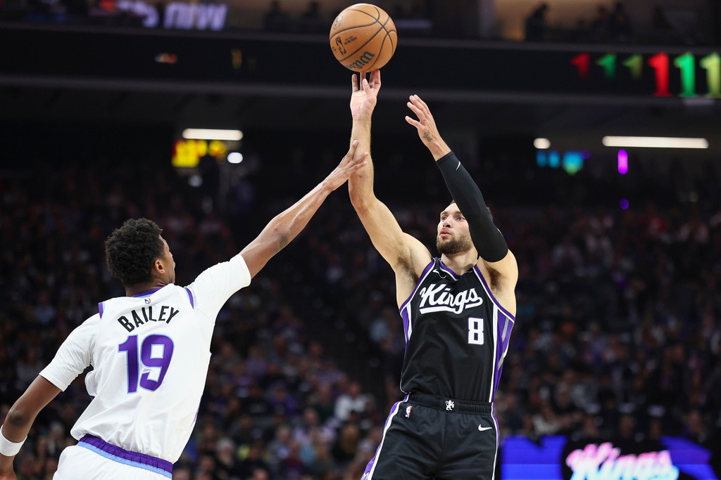 Sacramento Kings guard Zach Lavine (8) makes a jump shot over Utah Jazz forward Ace Bailey (19) during the first half of an NBA basketball game Friday, Oct. 24, 2025, in Sacramento, Calif. (AP Photo/Sara Nevis)