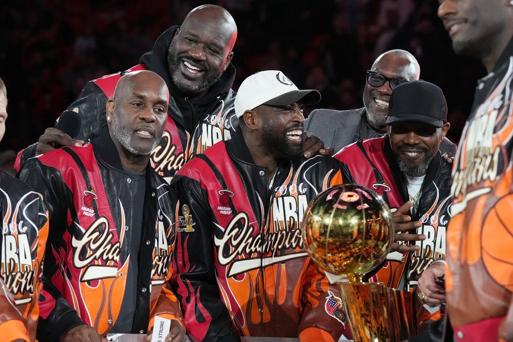 The Miami Heat 2006 NBA championship team pose with the trophy during a half time celebration Tuesday, Feb. 3, 2026, in Miami. (AP Photo/Marta Lavandier)